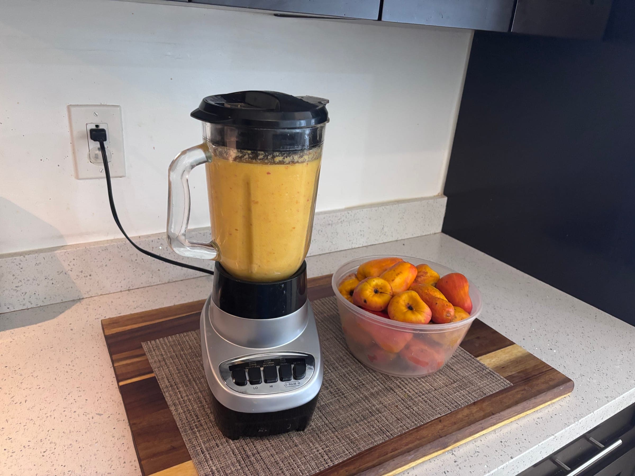 Ripe cashew apples blended into vivid orange juice