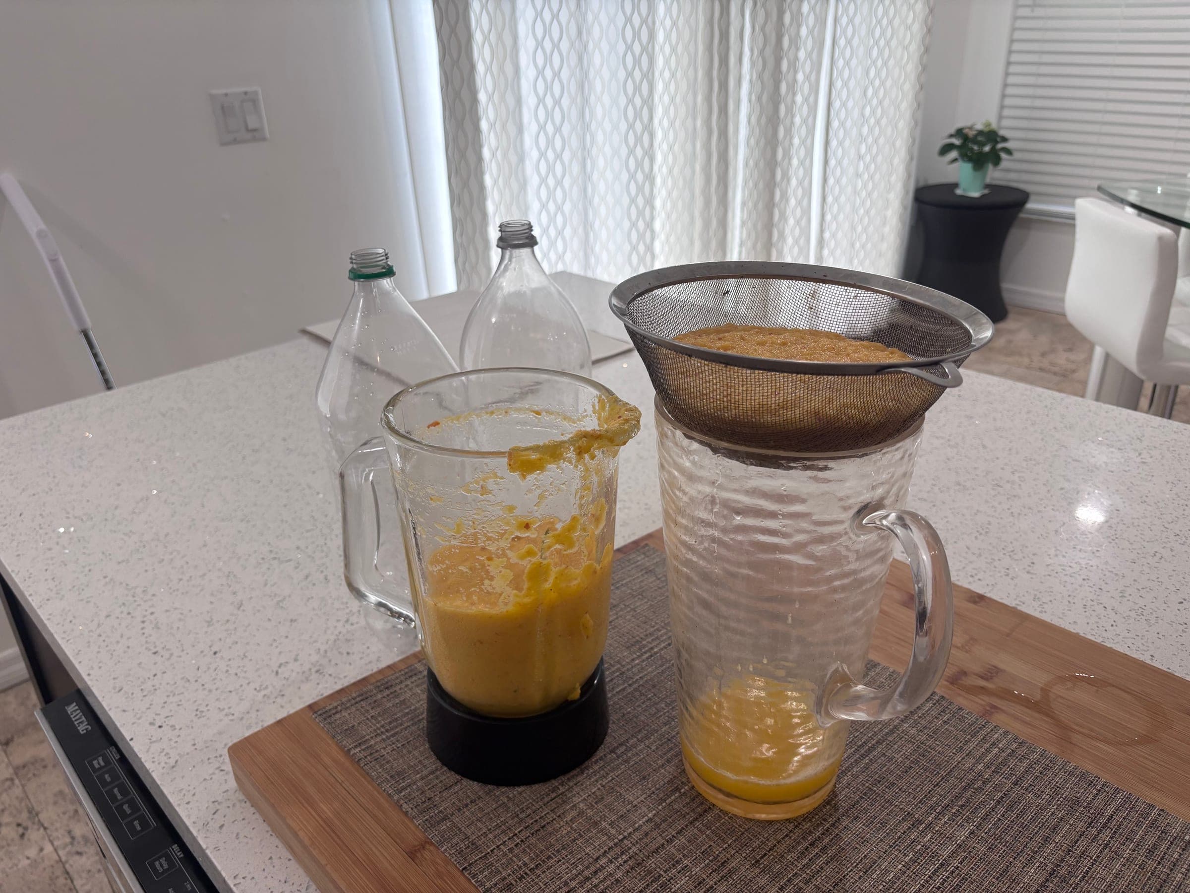 Straining the cashew pulp to press out the juice